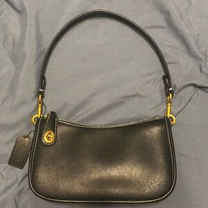 Coach brass and black Swinger bag, gently used and in excellent condition.
